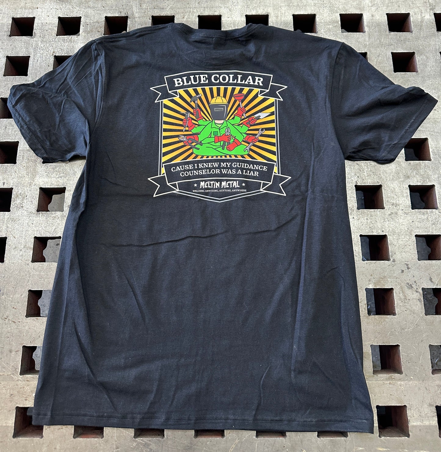 Black t-shirt with a colorful graphic design on a textured surface