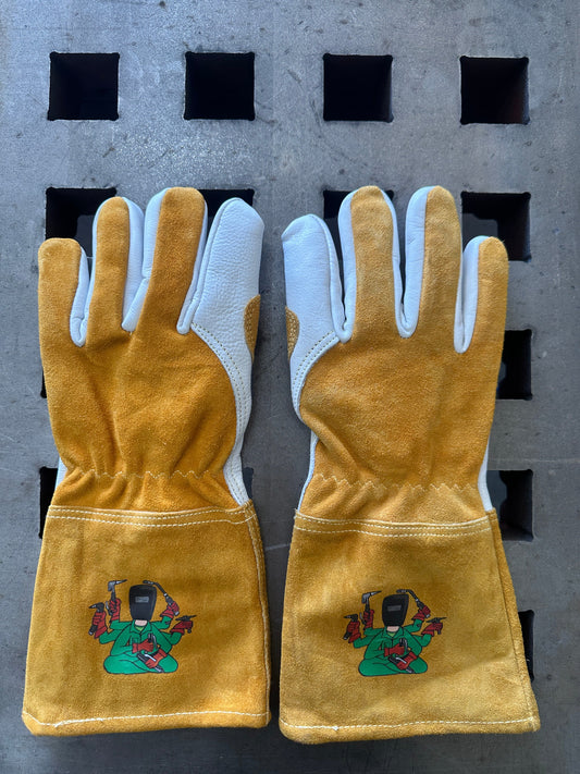Pair of light brown gloves with green embroidered designs on a gray background