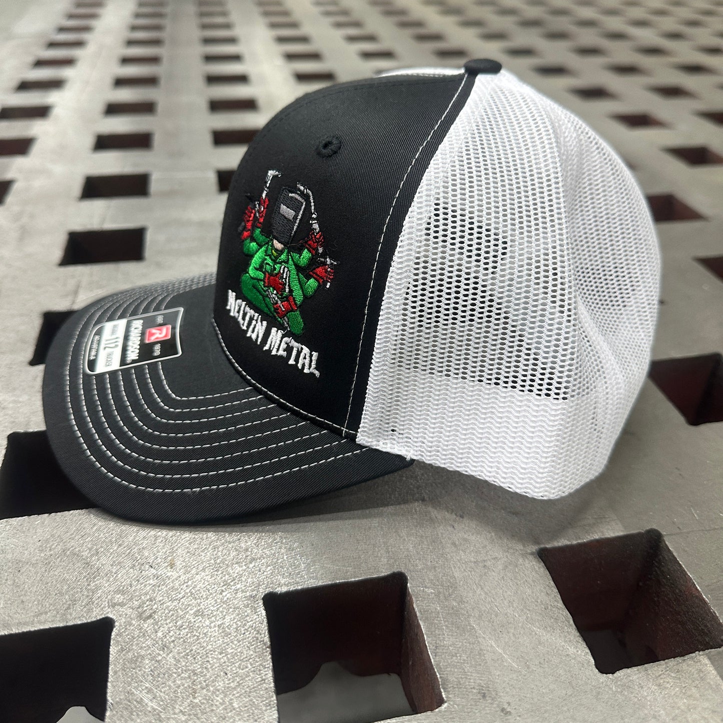 Black and white cap with a logo on a textured surface